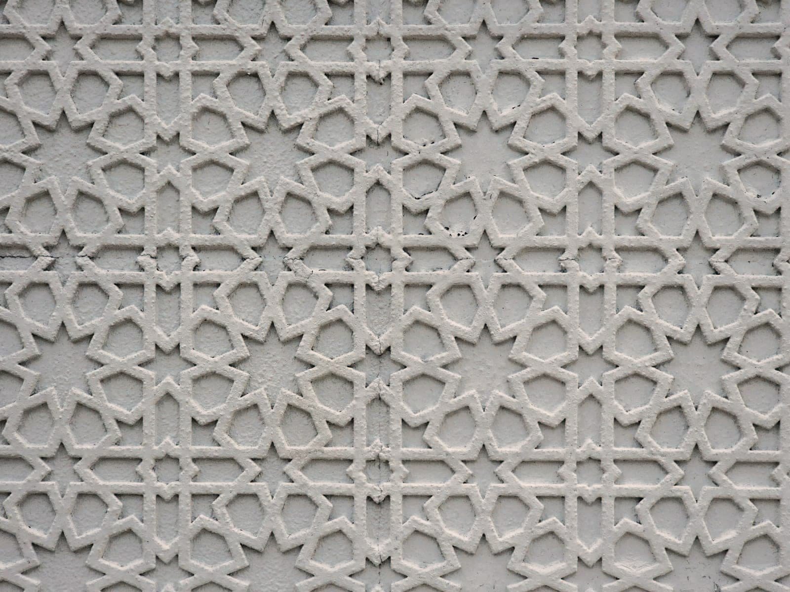 Hand-carved geometric pattern in white plaster