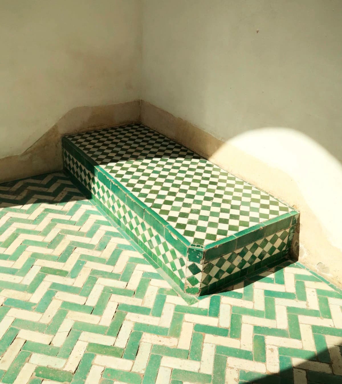 Sunlit bench in green and white zellige