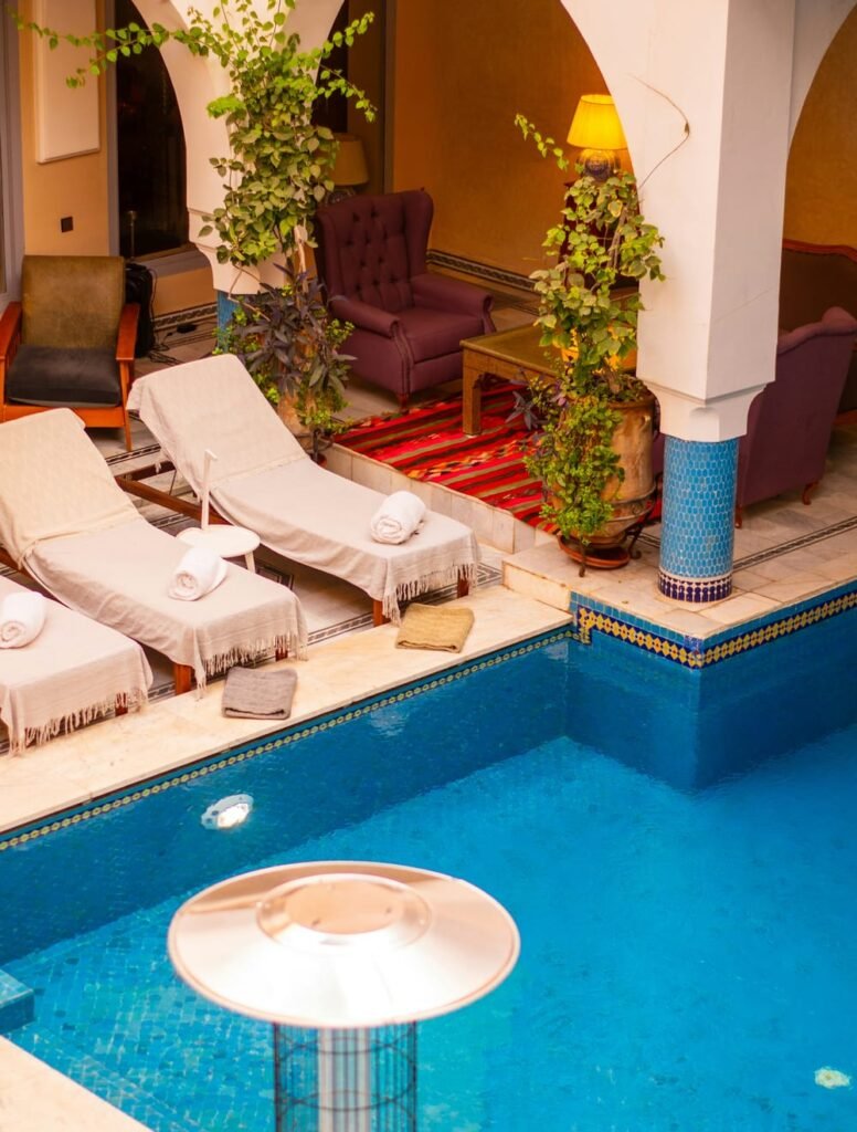Sun loungers and folded towels by the pool of a hotel in Marrakech