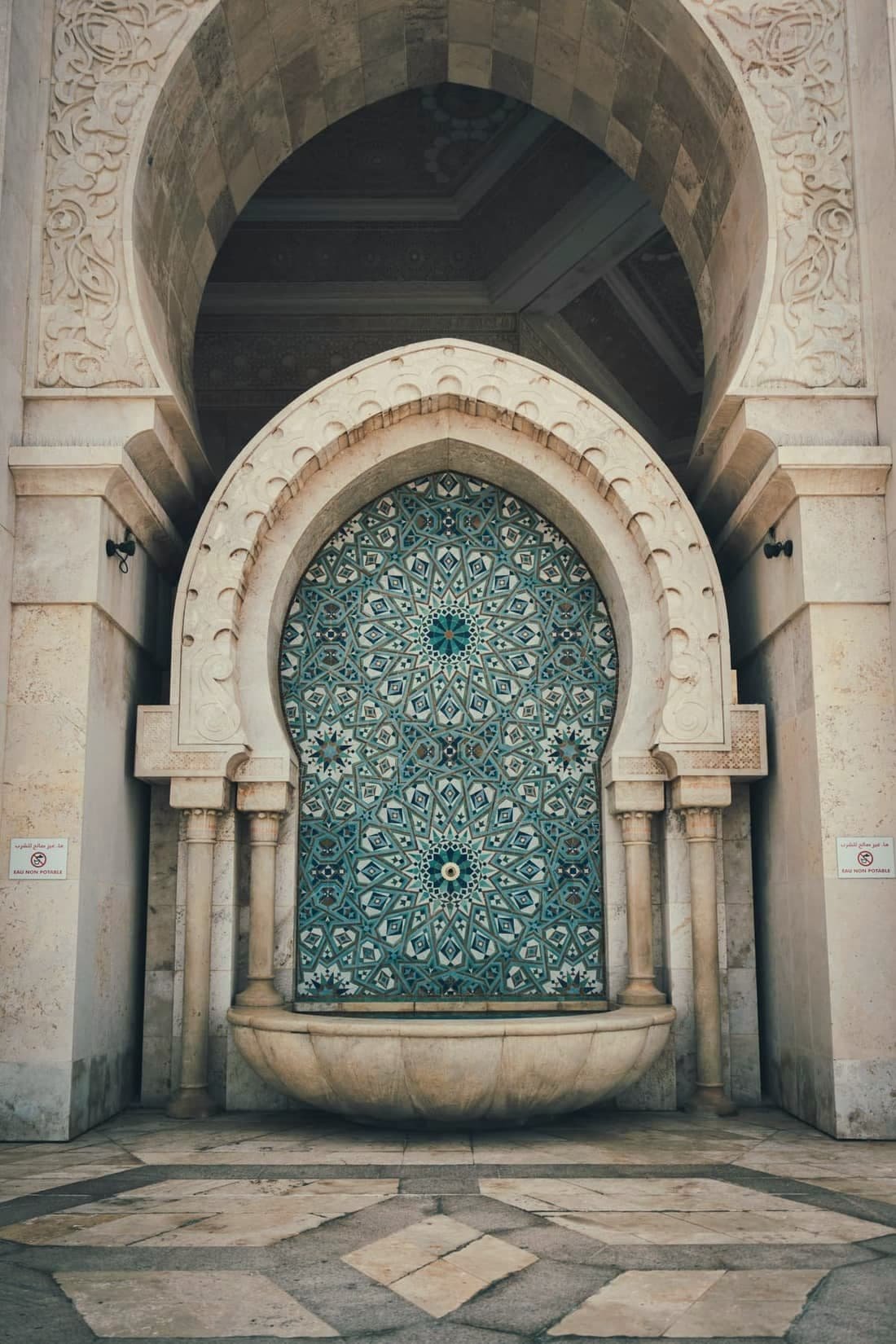 Large ornate door framed with plaster and zellige